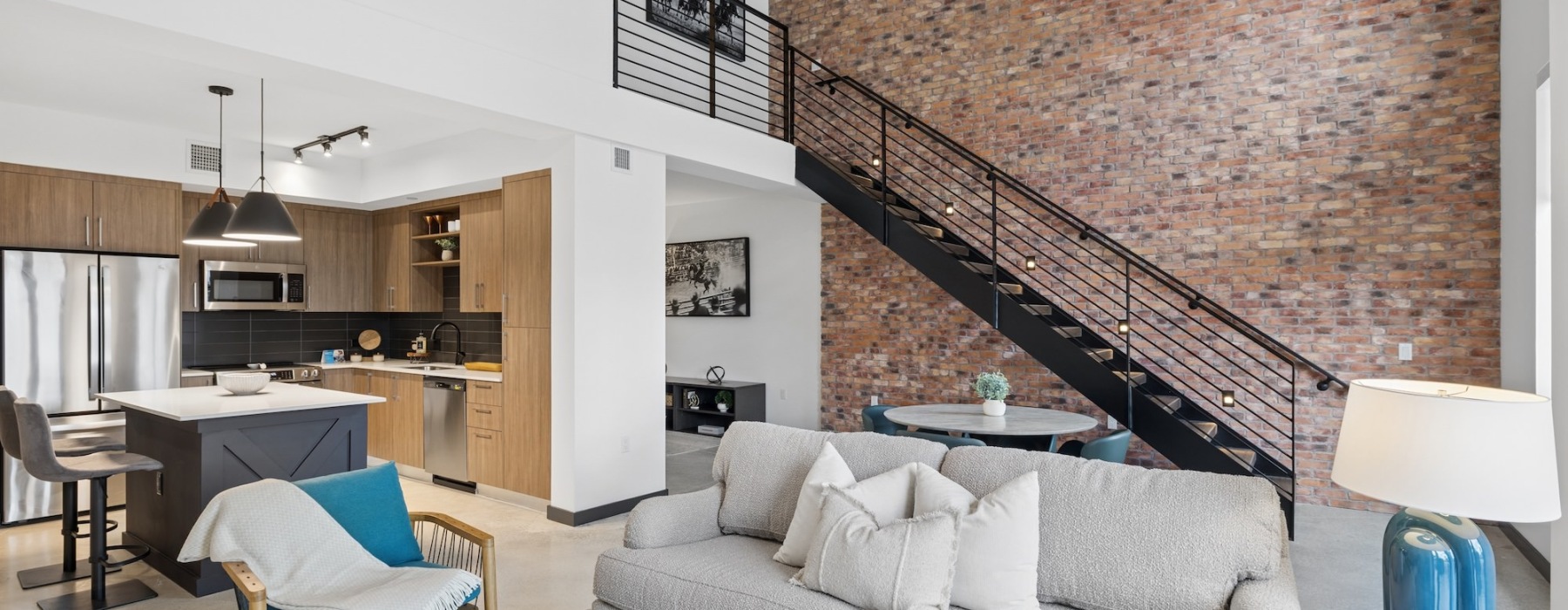 a room with a couch and chairs